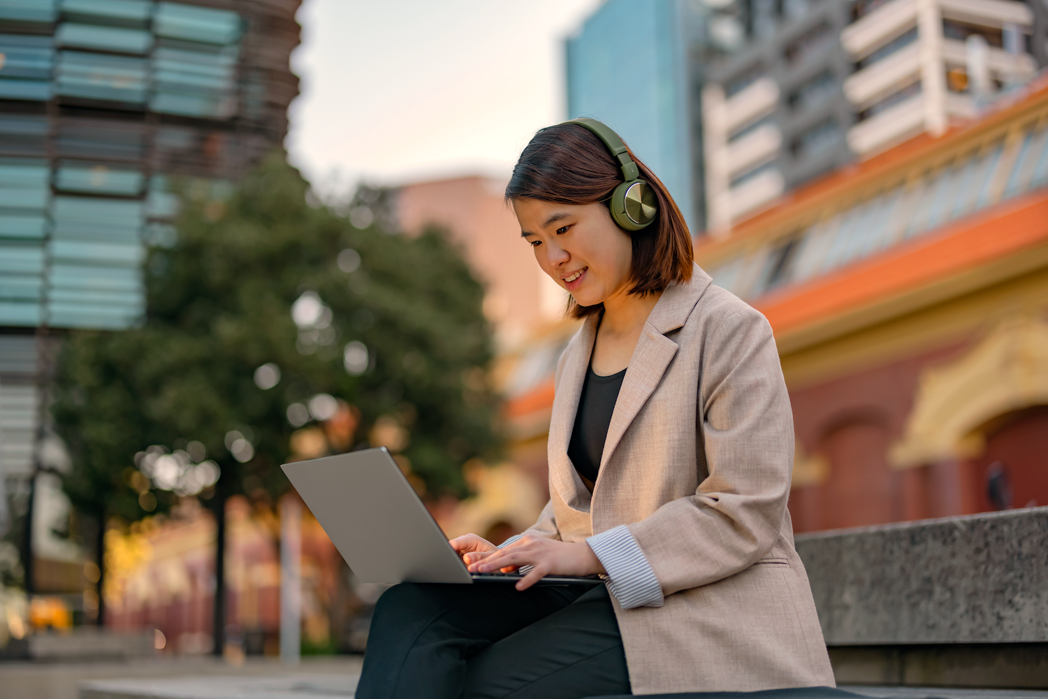 Young woman with headphones working on her laptop