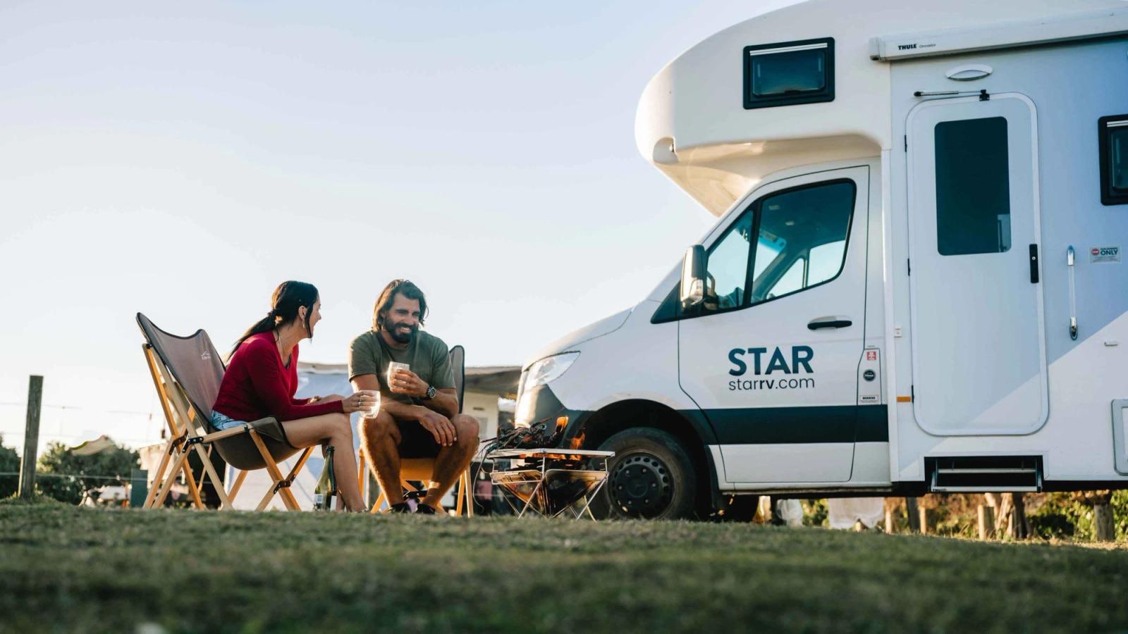 Couple enjoying a coffee by their Star RV camper